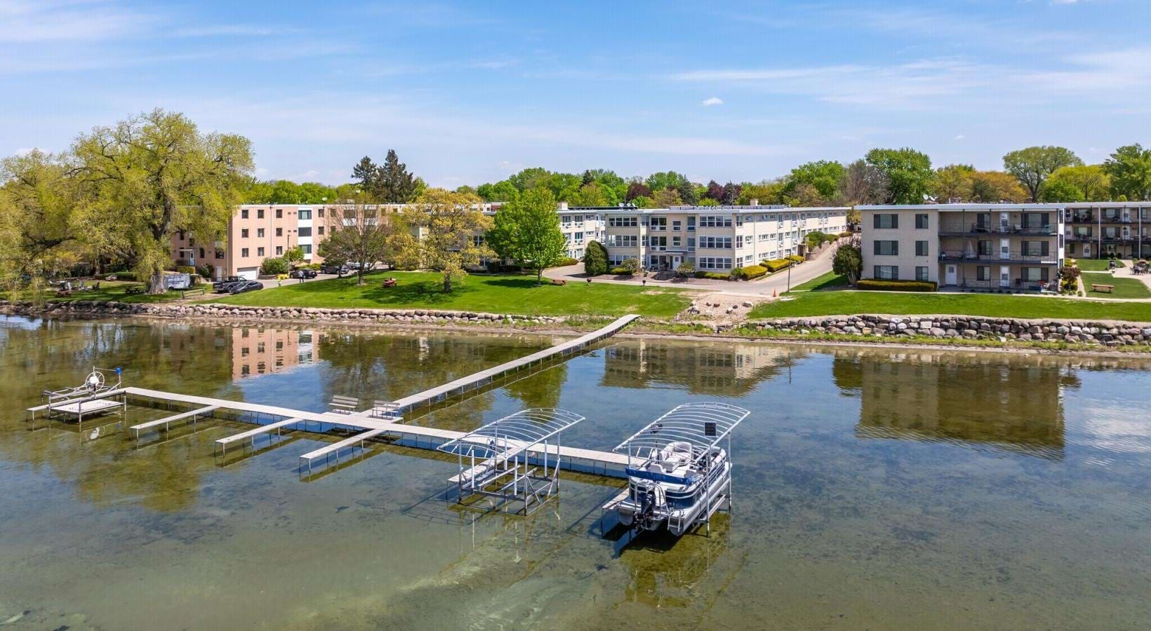 a body of water with a dock and buildings in the background